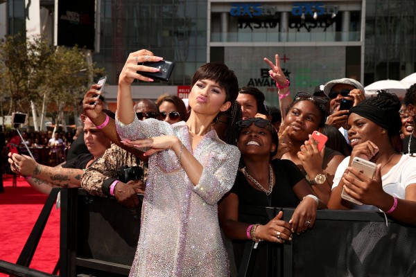 LOS ANGELES, CA - JUNE 28:  Recording artist Zendaya (C, holding mobile device) poses for a selfie photo with fans at the 2015 BET Awards at the Microsoft Theater on June 28, 2015 in Los Angeles, California.  (Photo by Christopher Polk/BET/Getty Images for BET)