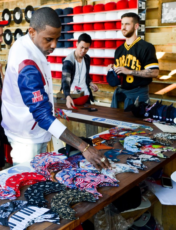 Hip hop artist Fabolous picks out a brim at the New Era booth on the second day of Philadelphia's Made in America festival, Septeber 25, 2015. (Mark C. Psoras)