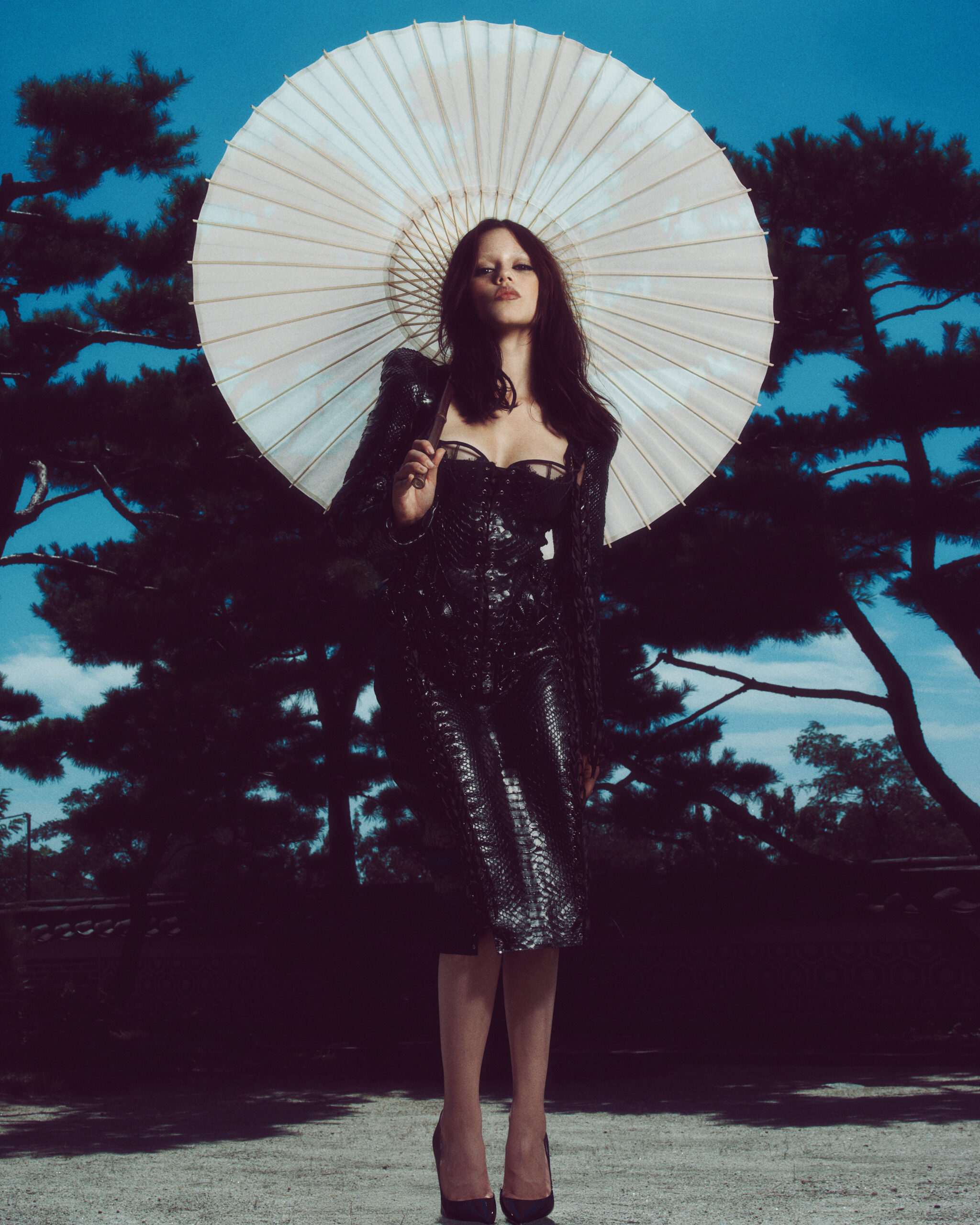 Celebrity Style: Jenna Ortega’s Black Leather Lace-Up Dress At Wednesday Photo Call In Korea